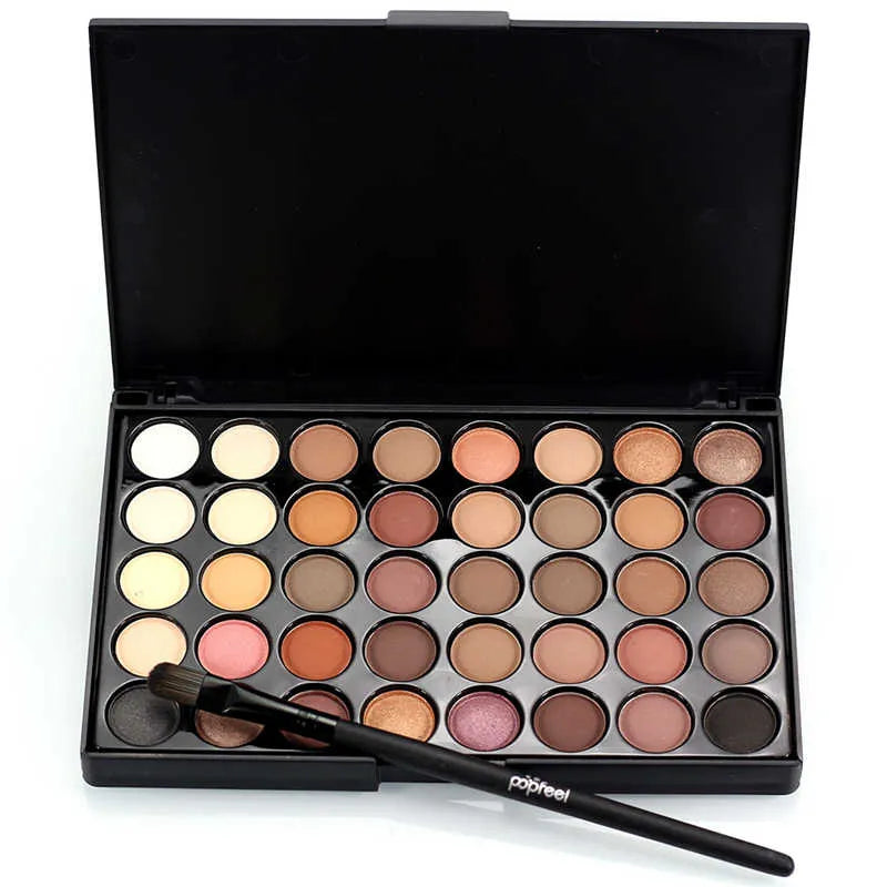 Eyeshadow palette with included brush on a neutral background