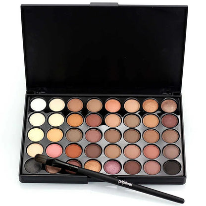 Eyeshadow palette with included brush on a neutral background