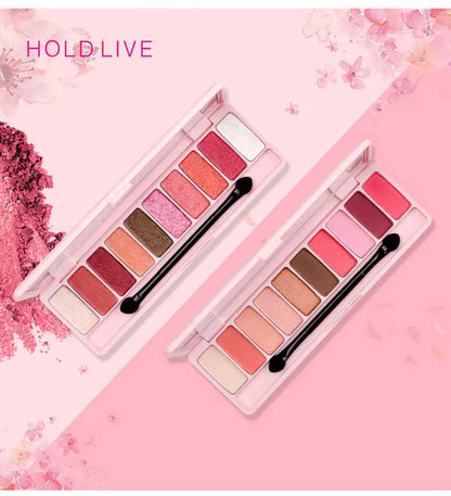 Close-up of red and pink glitter eyeshadow shades in palette