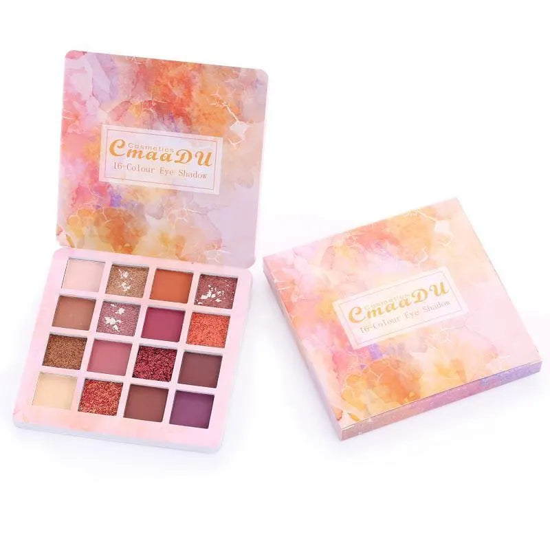 Close-up view of eyeshadow pans with pigmented matte and glitter textures