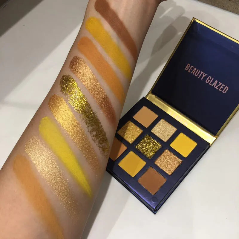 Compact eyeshadow palette with 9 shimmer and metallic colors arranged in a grid