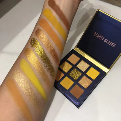 Compact eyeshadow palette with 9 shimmer and metallic colors arranged in a grid