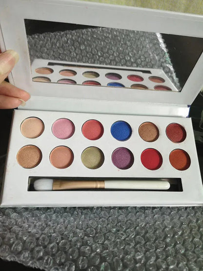 Open eyeshadow palette showing 12 shades in peach and nude colors