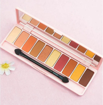 Eyeshadow palette with brush on neutral background