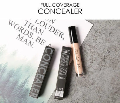 Close-up view of creamy concealer texture being blended on skin surface