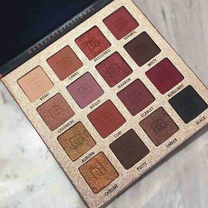 Close-up view of eyeshadow palette with brush applicator