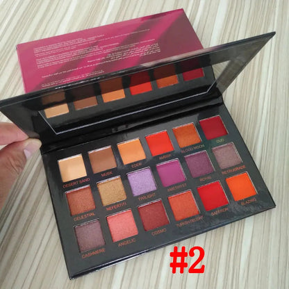 Eyeshadow palette in use with makeup brush applying pigment