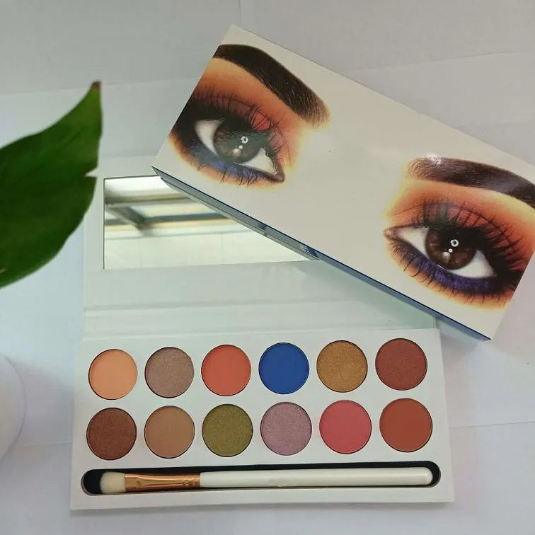 Compact eyeshadow palette with a mirror and applicator included