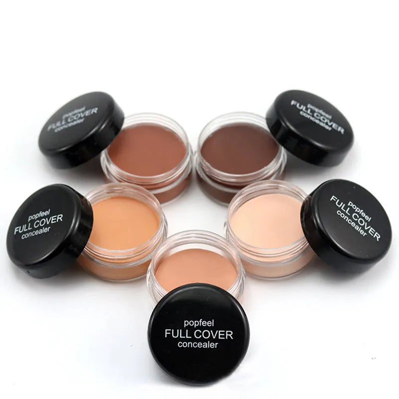 Close-up view of creamy makeup formula being applied to skin with brush