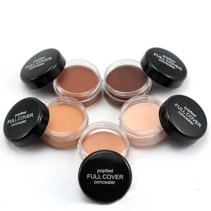 Close-up view of creamy makeup formula being applied to skin with brush