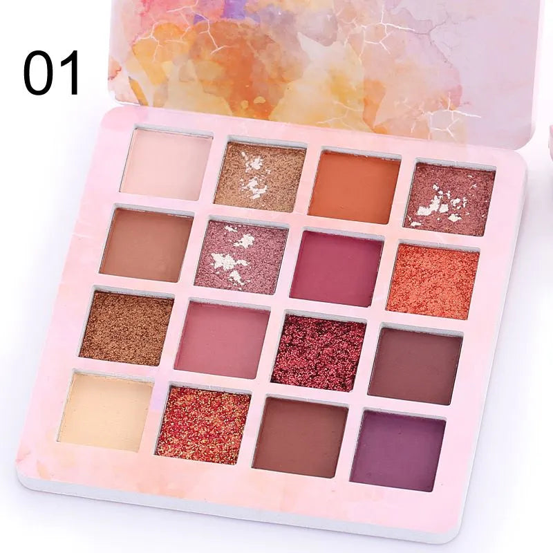 Close-up view of eyeshadow pans with pigmented matte and glitter textures