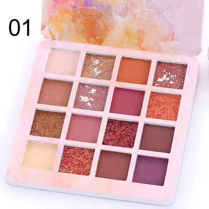Close-up view of eyeshadow pans with pigmented matte and glitter textures