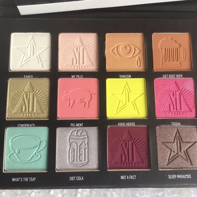 Open eyeshadow palette showing 18 different color shades