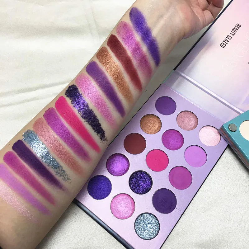 Eyeshadow palette with applicator tool on cosmetic background