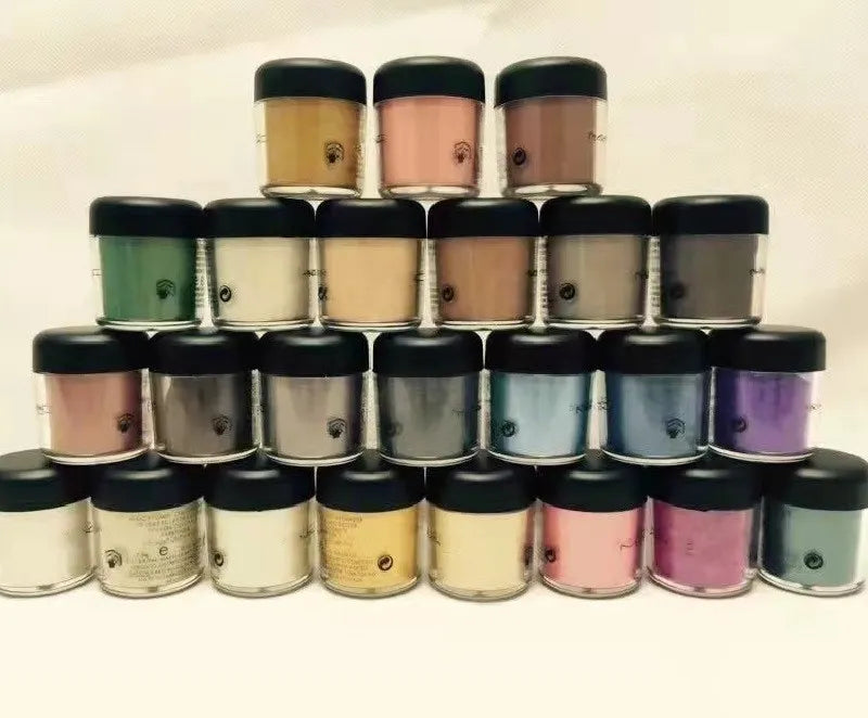Individual eyeshadow pigment containers with English color names visible